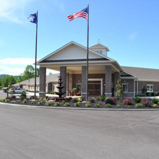 Welcoming entrance of a hotel with flags fluttering in the breeze.