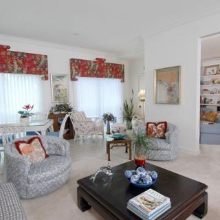 A cozy and elegantly designed living room with stylish furniture and vibrant curtains.