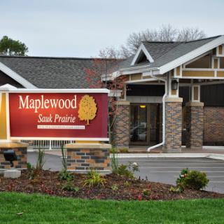 Exterior view of the Maplewood Senior Living facility, showcasing its welcoming entrance and landscaped surroundings.
