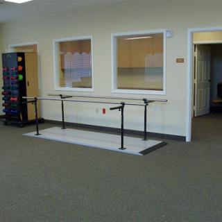 A ballet bar setup in a spacious dance studio.