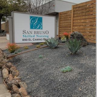 Exterior view of a dental office with landscaped plants.