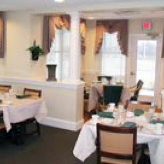 A cozy dining room setup with neatly arranged tables and elegant decor.
