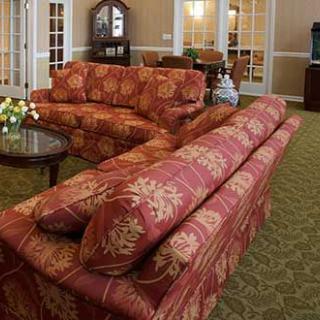 A cozy living room with floral patterned sofas and elegant furniture.