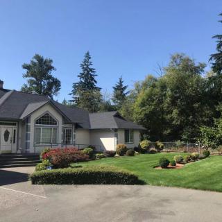 A well-maintained house with a landscaped garden and a spacious lawn.