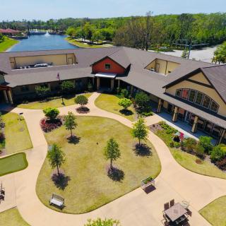 Aerial view of a landscaped courtyard surrounded by a building with scenic greenery and walkways.