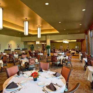 An elegant restaurant interior featuring neatly arranged tables and chairs.