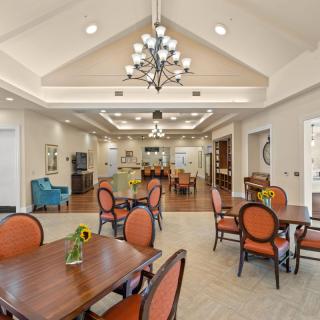 Elegant dining area with chandeliers and well-arranged furniture.