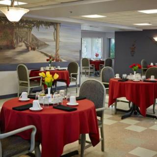 A well-decorated dining area with red tablecloths and neatly arranged tables.