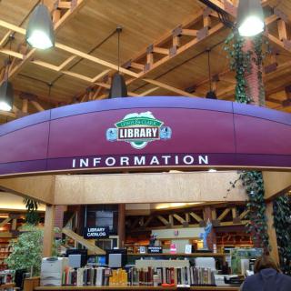 Information desk inside a library with wooden architecture.