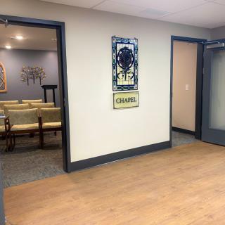 An office waiting area with chairs and artwork on the walls.