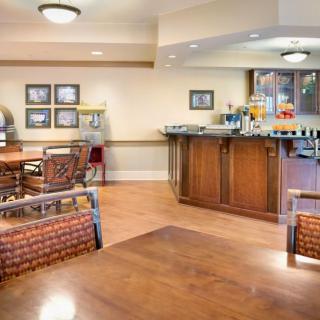 A cozy cafe interior with wooden floors and comfortable seating.