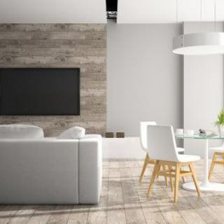 A modern, minimalist living room with a sleek sofa, dining area, and large TV.