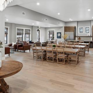 A spacious open-concept living area featuring a dining table, kitchen, and seating area with modern decor.