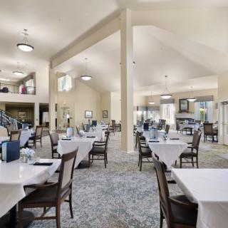A spacious and modern dining area with neatly arranged tables and chairs.