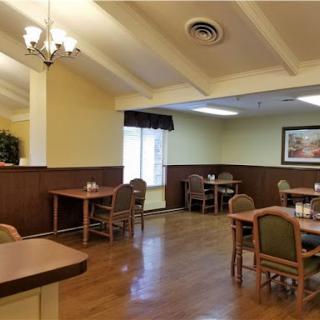 A cozy dining area featuring wooden floors and comfortable seating.
