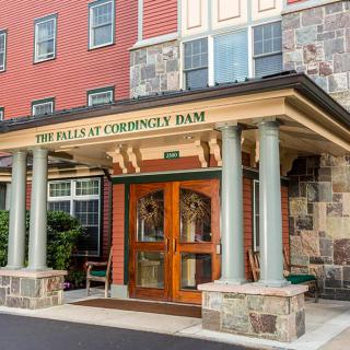The entrance to a hotel with stonework and columns.