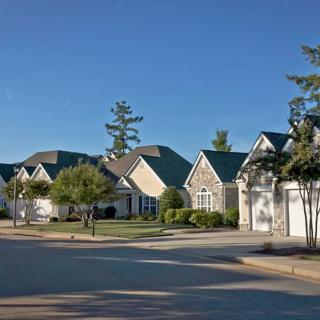A row of suburban houses in a quiet residential neighborhood during the day.