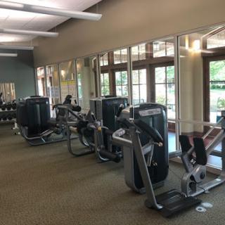 A view of a well-equipped gym showcasing various exercise machines.