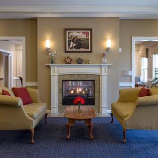 A cozy living room with a fireplace and traditional decor.