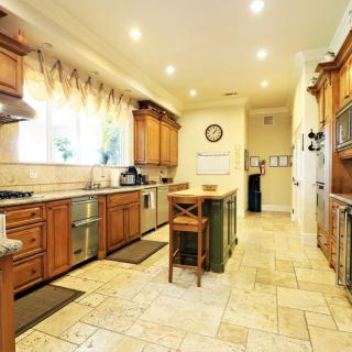 A spacious and modern kitchen with wooden cabinets and a central island.
