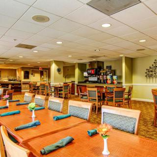 A spacious dining area with neatly arranged tables and chairs, ready for guests.