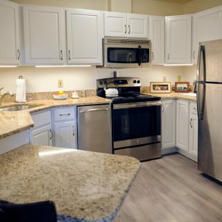A modern kitchen with stainless steel appliances and granite countertops.