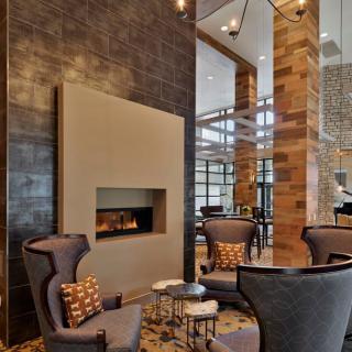 A modern lobby with a cozy seating area and fireplace.