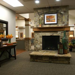 A cozy, modern interior featuring a stone fireplace and stylish decor.