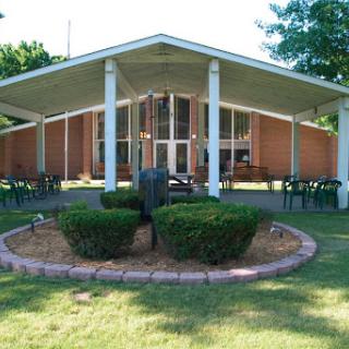A modern architectural building surrounded by well-maintained landscaping.