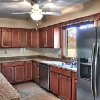 A modern kitchen featuring wooden cabinets and stainless steel appliances.