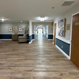 A well-lit hallway featuring wooden flooring and modern decor.