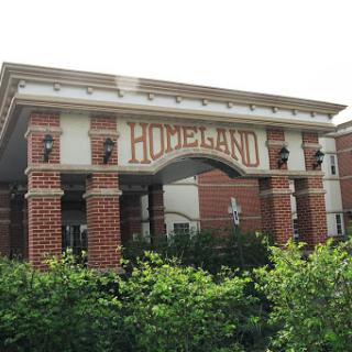 A well-designed brick building with 'HODELAND' prominently displayed on the facade.