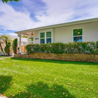 A well-maintained suburban house with a lush green lawn and landscaping.