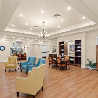 A modern living room with comfortable seating and a chandelier.