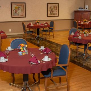 A beautifully arranged dining area with round tables set for guests.
