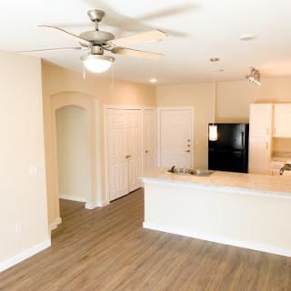 A spacious and modern open-plan living area featuring a kitchen, dining space, and comfortable ambiance.