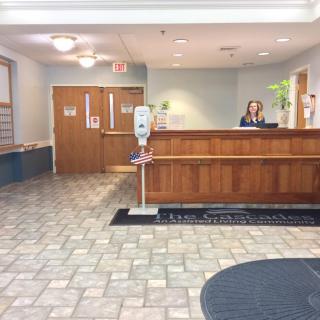 A reception area with a front desk in a lobby setting.