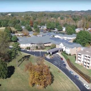 An aerial view of a residential community surrounded by lush greenery.