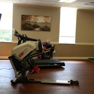 A spacious gym area featuring a treadmill and a rowing machine, perfect for a complete workout.