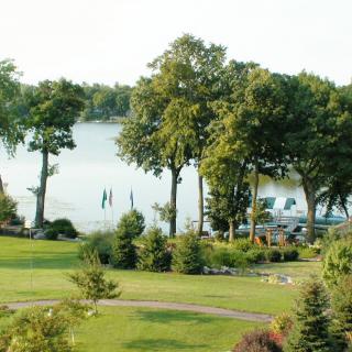A tranquil lakeside scene with lush greenery and calm waters.