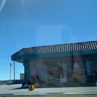 A sunny day highlighting a commercial building with a tiled roof.