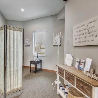 A cozy hallway with wall art and organized wooden furniture.