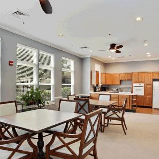 A modern kitchen and dining area with wooden furniture and ample natural light.