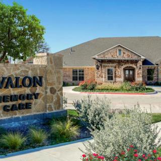 A healthcare facility with a well-maintained entrance and a sign reading 'Avalon Memory Care'.