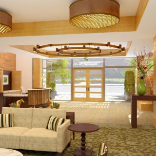 A luxurious hotel lobby featuring modern decor with wood accents and elegant chandeliers.