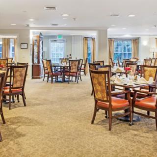 An elegant dining room with neatly arranged tables and chairs, ready for guests.