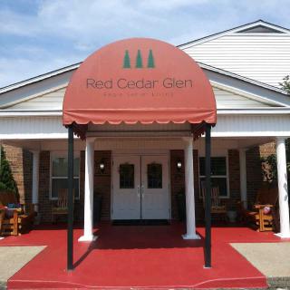 The entrance to the Red Cedar Inn features a distinctive red awning.