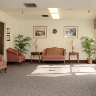 A quiet and well-lit waiting room with seating and decor.