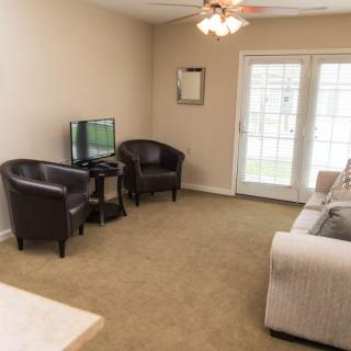 A cozy living room with comfortable seating and a television.