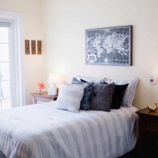 A cozy and modern bedroom with stylish decor and comfortable bedding.